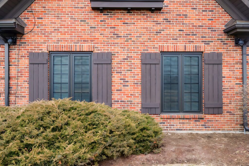 residential security screens on a brick house