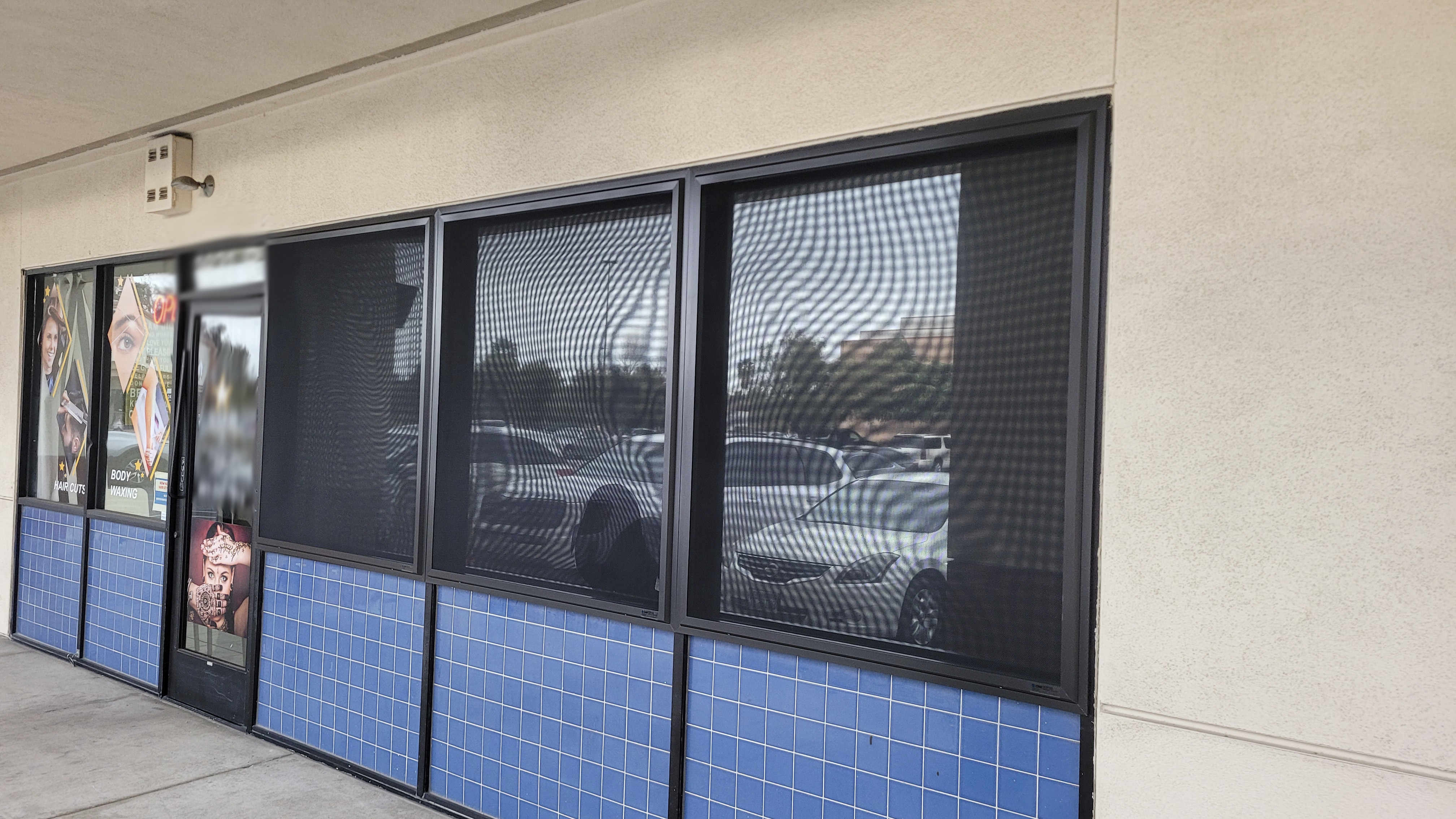 commercial window security screens on a salon
