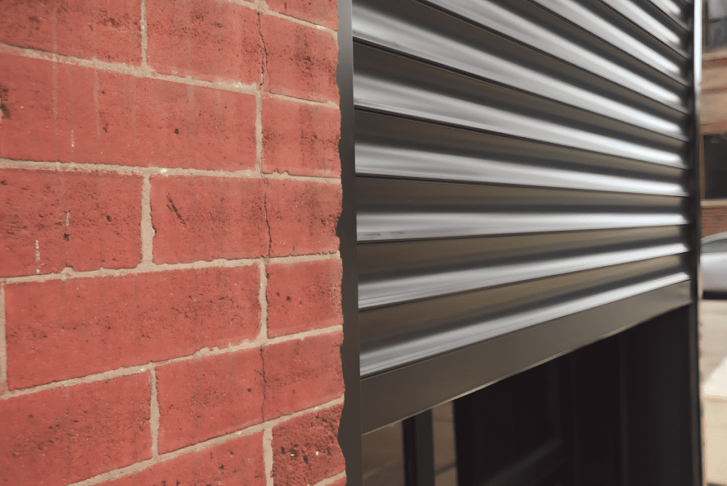 Black shutter protecting an outdoor restaurant